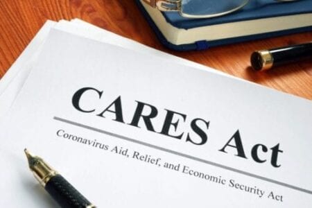 Coronavirus Aid, Relief, and Economic Security CARES Act on the desk.